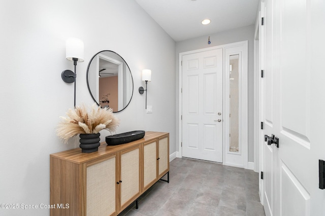foyer featuring recessed lighting and baseboards