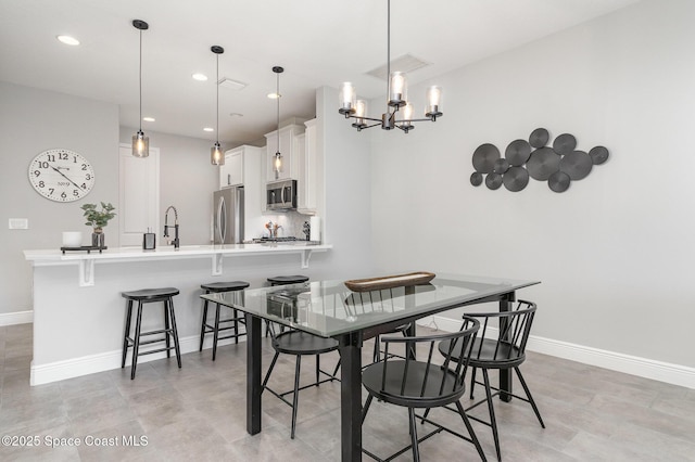 dining space featuring a chandelier, baseboards, visible vents, and recessed lighting
