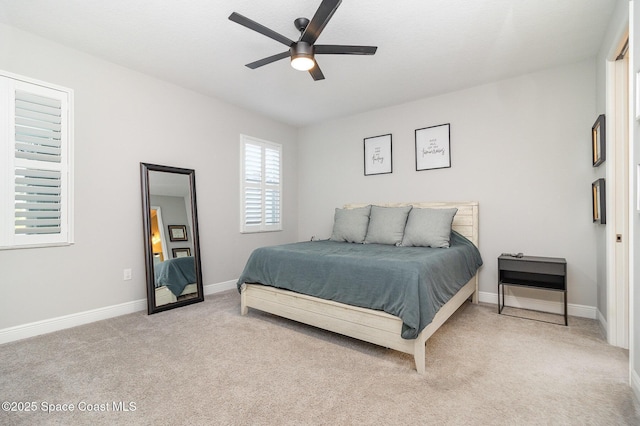 bedroom featuring baseboards, a ceiling fan, and light carpet
