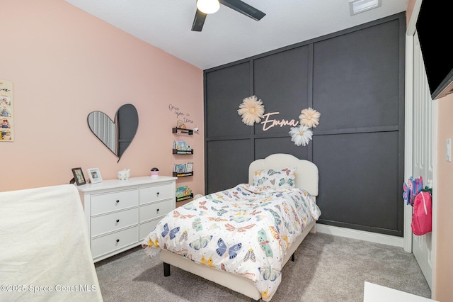carpeted bedroom featuring visible vents and a ceiling fan