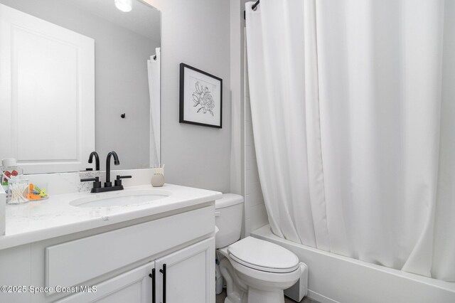 bathroom with shower / tub combo, toilet, and vanity