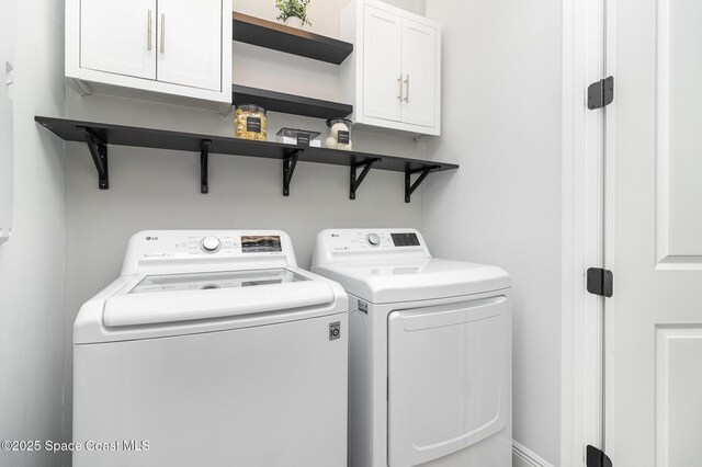 laundry room featuring washer and dryer and cabinet space
