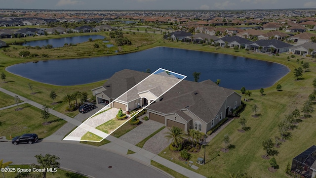 drone / aerial view featuring a residential view and a water view