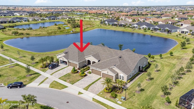 birds eye view of property featuring a water view and a residential view