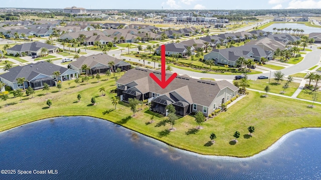 drone / aerial view with a residential view and a water view