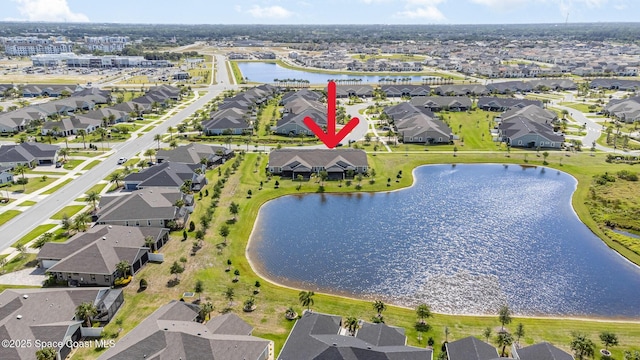 birds eye view of property with a water view and a residential view