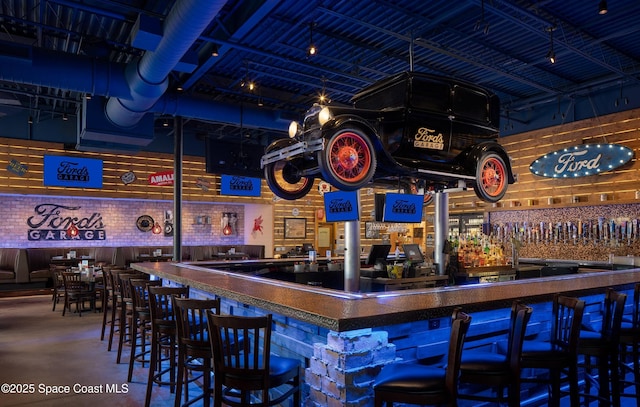 bar with a dry bar and finished concrete floors