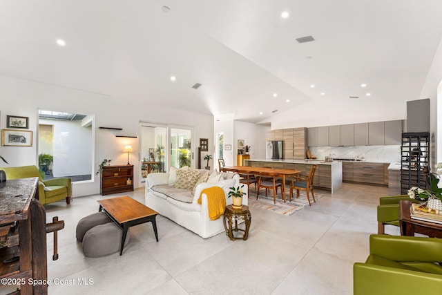 living room with recessed lighting, concrete flooring, visible vents, and vaulted ceiling