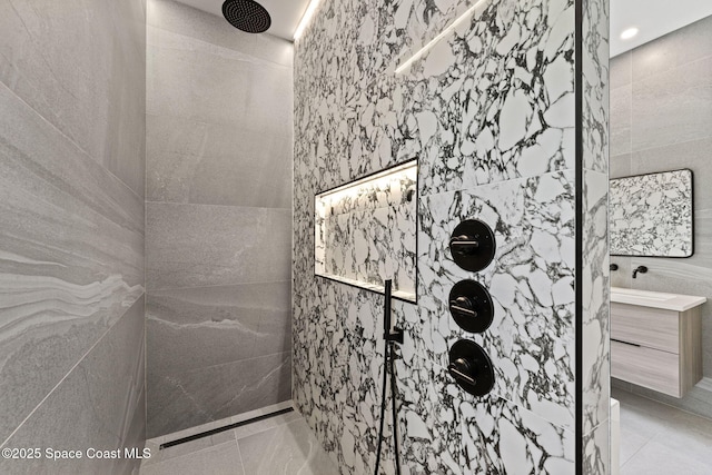full bath with tile patterned floors, tile walls, and tiled shower