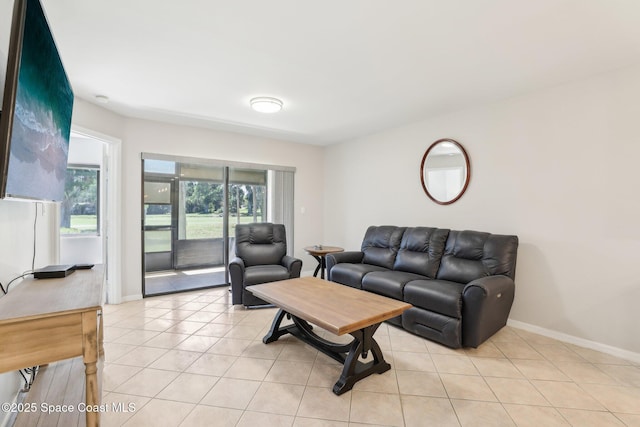 living area featuring light tile patterned floors and baseboards
