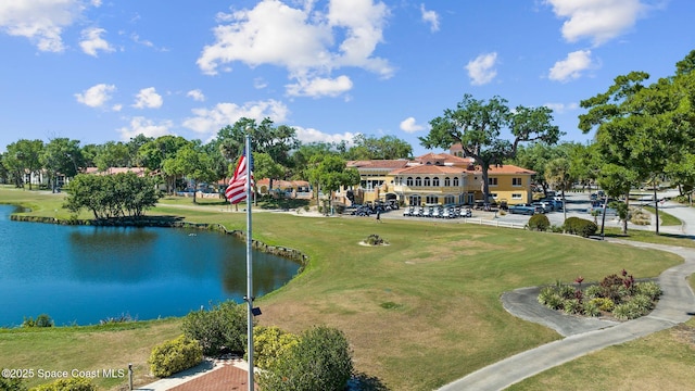 surrounding community featuring a yard, view of golf course, and a water view