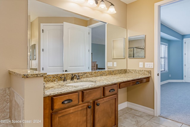 bathroom featuring tile patterned floors, vanity, and baseboards