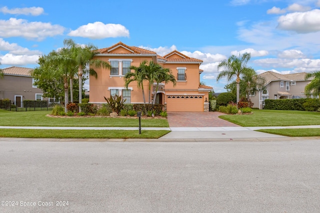 view of front of property featuring a garage, a tile roof, stucco siding, a front lawn, and decorative driveway