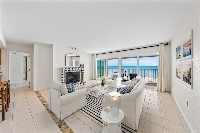 2101 Atlantic St Unit 531, Melbourne Beach, FL 32951 - living area with a water view, a tile fireplace, baseboards, and light tile patterned floors