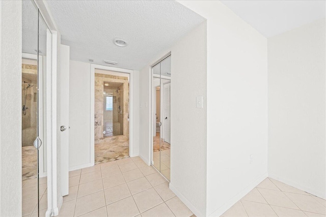 2101 Atlantic St Unit 531, Melbourne Beach, FL 32951 - corridor with light tile patterned floors and a textured ceiling
