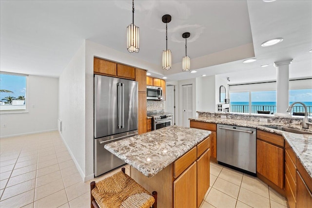 2101 Atlantic St Unit 531, Melbourne Beach, FL 32951 - kitchen featuring a sink, brown cabinetry, light tile patterned flooring, and stainless steel appliances