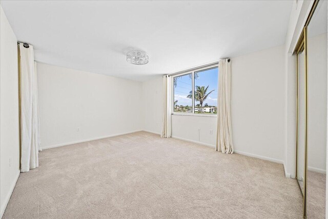 2101 Atlantic St Unit 531, Melbourne Beach, FL 32951 - unfurnished bedroom featuring carpet floors, baseboards, and a closet