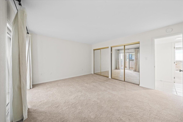 2101 Atlantic St Unit 531, Melbourne Beach, FL 32951 - unfurnished bedroom featuring baseboards, multiple closets, and carpet floors