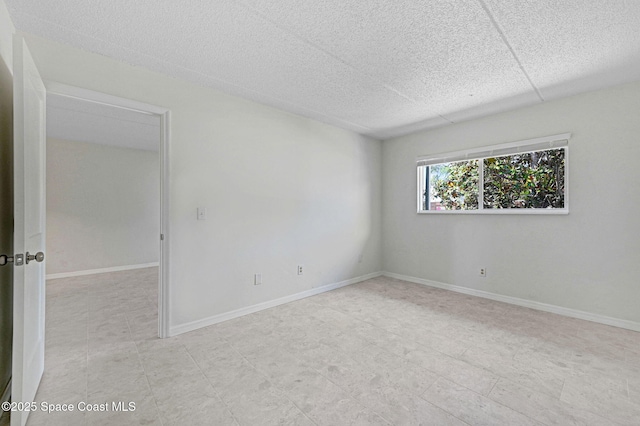 unfurnished room featuring baseboards