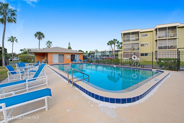 pool with fence and a patio