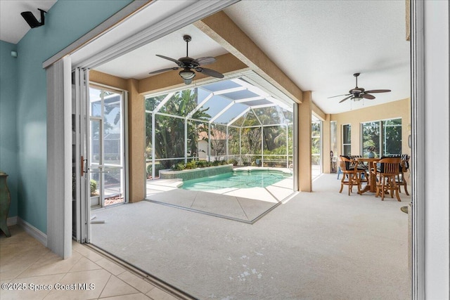 pool with a ceiling fan, a patio, and glass enclosure