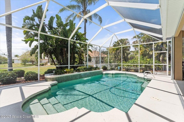 outdoor pool featuring a patio and glass enclosure