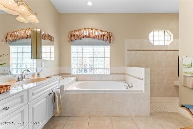 bathroom with a bath, tile patterned floors, walk in shower, and vanity