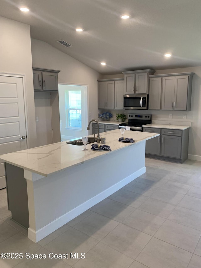 kitchen featuring gray cabinetry, a sink, and stainless steel appliances