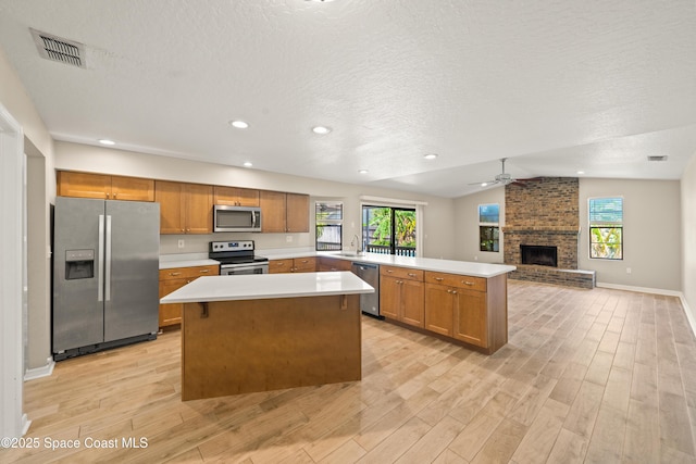 508 Carriage Rd, Indian Harbour Beach, FL 32937 - kitchen with a textured ceiling, light wood finished floors, lofted ceiling, and stainless steel appliances