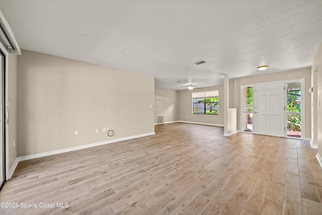 508 Carriage Rd, Indian Harbour Beach, FL 32937 - unfurnished living room with light wood-style floors and baseboards
