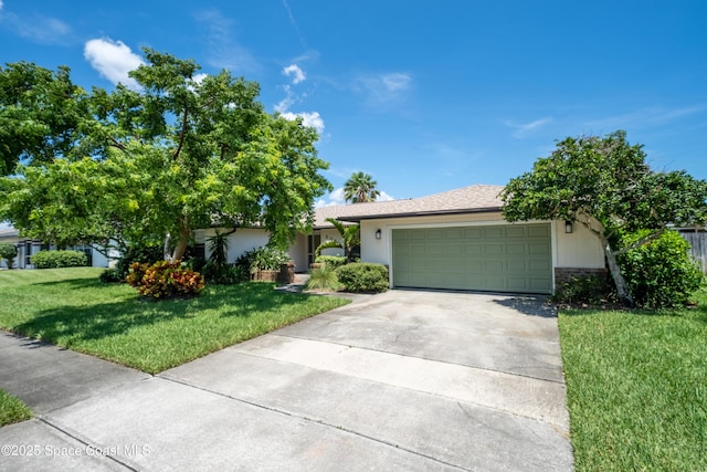 508 Carriage Rd, Indian Harbour Beach, FL 32937 - single story home with a front yard, an attached garage, concrete driveway, stucco siding, and brick siding
