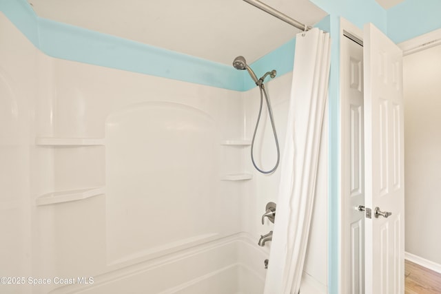 508 Carriage Rd, Indian Harbour Beach, FL 32937 - bathroom featuring shower / bathtub combination with curtain and wood finished floors