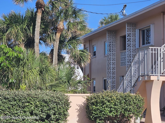 1700 Atlantic St Unit 12, Melbourne Beach, FL 32951 - view of property exterior featuring stairs and stucco siding