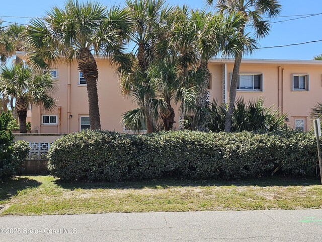 1700 Atlantic St Unit 12, Melbourne Beach, FL 32951 - exterior space featuring stucco siding and a front lawn