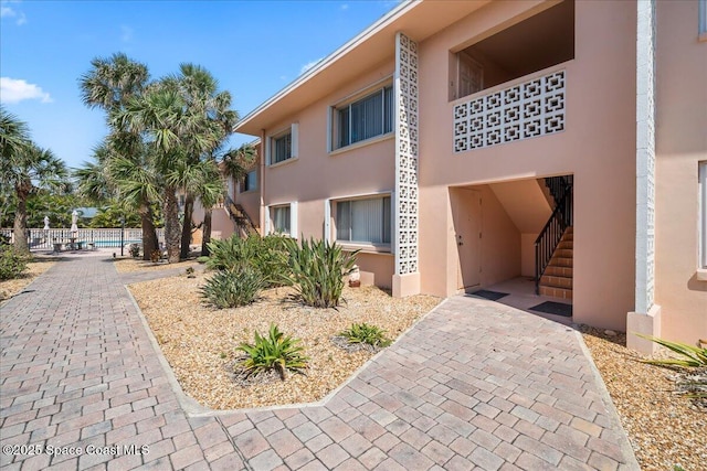 1700 Atlantic St Unit 12, Melbourne Beach, FL 32951 - view of property with fence and stairway