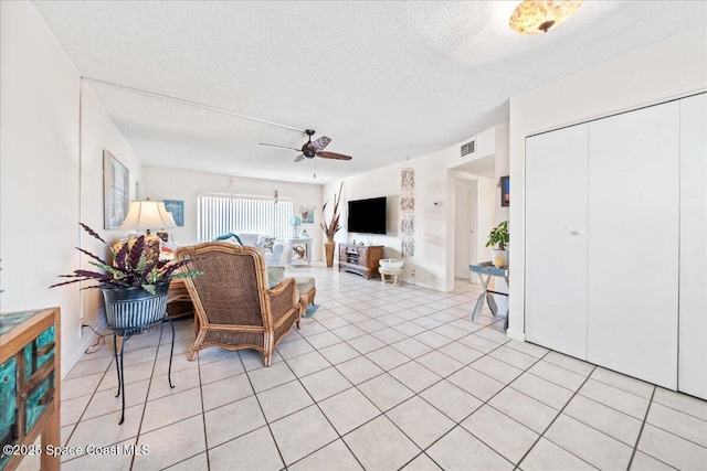 1700 Atlantic St Unit 12, Melbourne Beach, FL 32951 - living area featuring a ceiling fan, visible vents, a textured ceiling, and light tile patterned floors