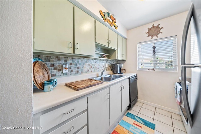 1700 Atlantic St Unit 12, Melbourne Beach, FL 32951 - kitchen featuring a sink, freestanding refrigerator, decorative backsplash, dishwasher, and light countertops