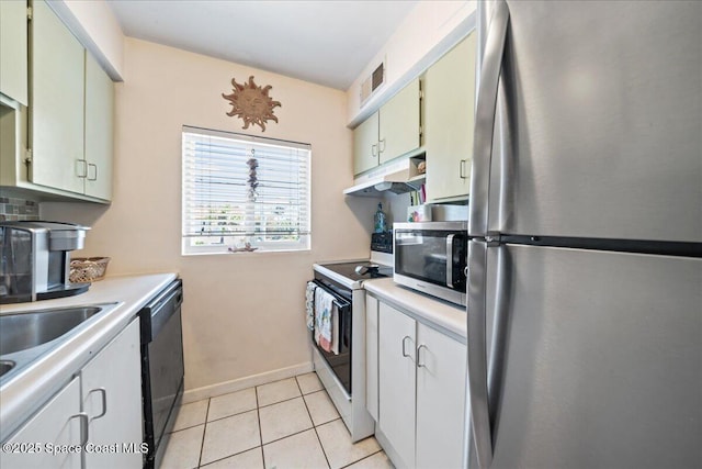 1700 Atlantic St Unit 12, Melbourne Beach, FL 32951 - kitchen featuring stainless steel appliances, visible vents, light countertops, under cabinet range hood, and light tile patterned floors