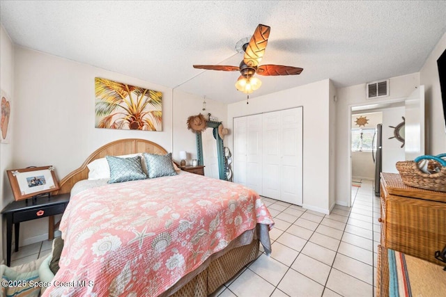 1700 Atlantic St Unit 12, Melbourne Beach, FL 32951 - bedroom with freestanding refrigerator, visible vents, a closet, ceiling fan, and light tile patterned floors