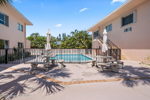 1700 Atlantic St Unit 12, Melbourne Beach, FL 32951 - view of swimming pool with a fenced in pool, a patio, and stairway