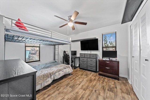 bedroom featuring a closet, a ceiling fan, and wood finished floors