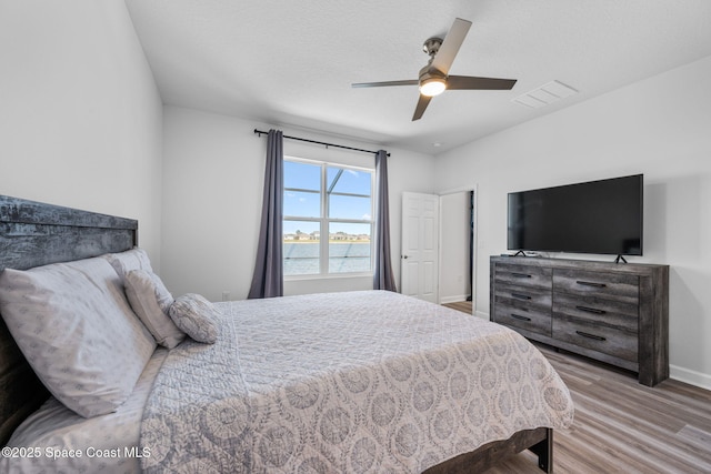 2631 Pinwherry St NW, Palm Bay, FL 32907 - bedroom with ceiling fan, visible vents, baseboards, and wood finished floors