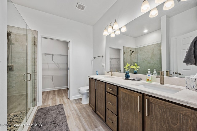 2631 Pinwherry St NW, Palm Bay, FL 32907 - bathroom with a shower stall, visible vents, a sink, and wood finished floors