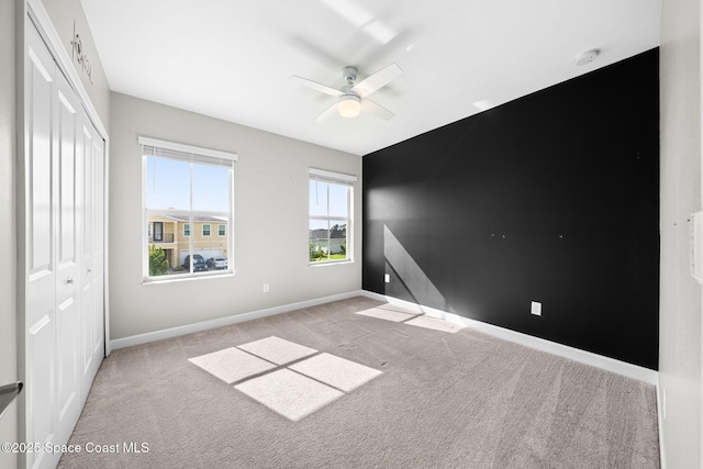 544 Veridian Cir NW, Palm Bay, FL 32907 - unfurnished bedroom featuring carpet flooring, a closet, baseboards, and ceiling fan