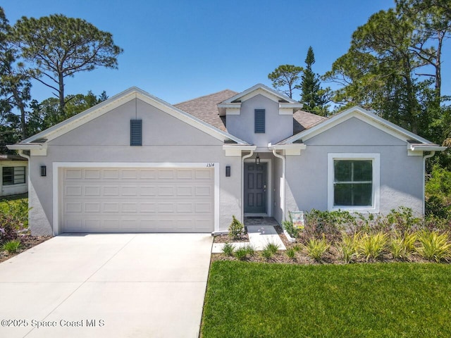 1314 Victory Palm Dr, Edgewater, FL 32132 - view of front of property featuring concrete driveway, an attached garage, and stucco siding
