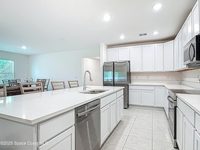 1314 Victory Palm Dr, Edgewater, FL 32132 - kitchen featuring recessed lighting, visible vents, a center island with sink, appliances with stainless steel finishes, and a sink