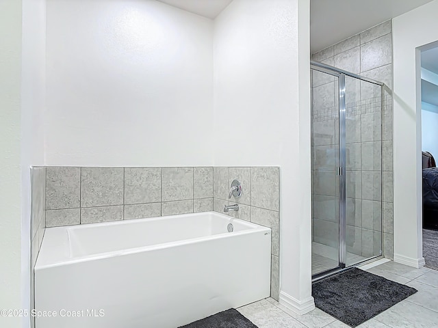 1314 Victory Palm Dr, Edgewater, FL 32132 - full bath with a shower stall, tile patterned flooring, baseboards, and a garden tub