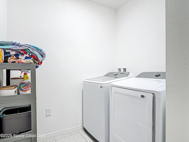 1314 Victory Palm Dr, Edgewater, FL 32132 - laundry area with light tile patterned floors, washer and dryer, and laundry area