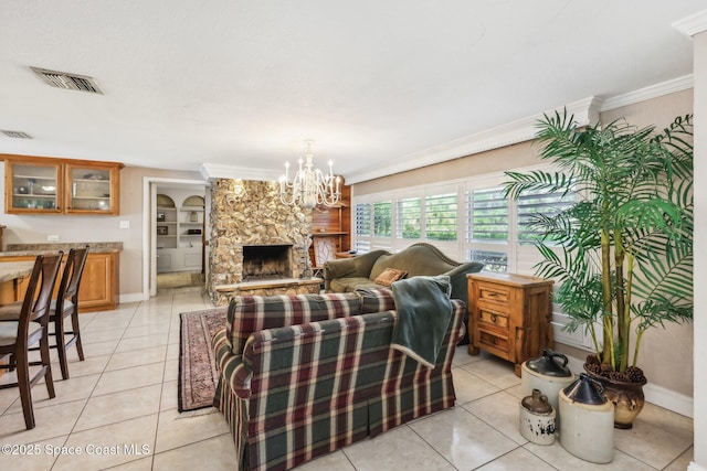 living room with visible vents, baseboards, crown molding, and light tile patterned flooring