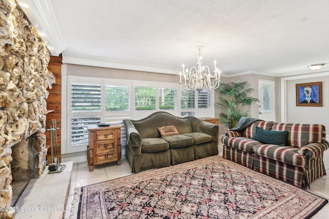 living area featuring an inviting chandelier, ornamental molding, and tile patterned flooring